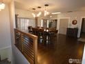 Elegant dining room showcasing hardwood floors, modern chandelier lighting, and staircase at 3310 Routt St, Wheat Ridge, CO 80033