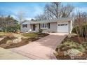 Lovely single-story home featuring a brick exterior, attached garage, and manicured front lawn at 350 Auburn St, Boulder, CO 80305