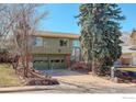 Two-story home with a two-car garage, complemented by mature landscaping and stone accents for a welcoming entrance at 4361 Butler Cir, Boulder, CO 80305