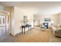 Open living area with neutral walls, plush carpet, and a view of adjacent rooms at 4631 Ashfield Dr, Boulder, CO 80301