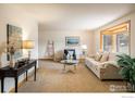 Bright living room featuring a neutral color palette, large windows, and comfortable seating at 4631 Ashfield Dr, Boulder, CO 80301