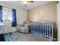 A cozy Bedroom with a crib, comfortable armchair, and charming decor at 465 S 24Th Ave, Brighton, CO 80601