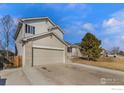 Two-story home with an attached garage, nice lawn, and manicured shrubbery at 465 S 24Th Ave, Brighton, CO 80601