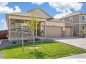 Charming single Gathering home featuring a three car garage and a welcoming front porch at 4723 Windmill Dr, Brighton, CO 80601