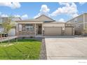 Charming single Gathering home featuring a three car garage and a welcoming front porch at 4723 Windmill Dr, Brighton, CO 80601