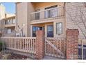 Inviting townhouse exterior featuring private entrance with wooden fence and brick accents at 5052 Buckingham Rd, Boulder, CO 80301