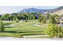 Scenic view of a community park with lush green grass, walking paths, and mountain views in the background at 555 Laramie Blvd, Boulder, CO 80304