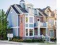 Charming three-story townhouse featuring a mix of brick and siding, complemented by large windows and a balcony at 555 Laramie Blvd, Boulder, CO 80304