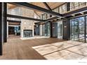 Bright living room showcasing hardwood floors, a soaring ceiling, and large windows at 775 Kalmia Ave, Boulder, CO 80304