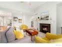 Bright living room featuring a cozy fireplace, modern furniture, and lots of natural light at 836 Windflower Dr, Longmont, CO 80504