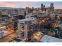 Stunning aerial view of the city skyline surrounding the apartment building at dusk at 888 N Logan St # 11E, Denver, CO 80203