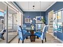 Stylish dining room with blue accents, a glass table, and views of the city at 888 N Logan St # 11E, Denver, CO 80203