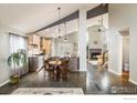 Open-concept kitchen and dining area with vaulted ceilings and modern finishes at 9094 W 103Rd Ave, Broomfield, CO 80021