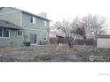 A view of the backyard with lawn and privacy fence from the home's exterior at 9852 W 76Th Ave, Arvada, CO 80005