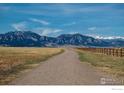 Scenic view of a walking path with mountains in the background on a sunny day at 1039 Willow Pl, Louisville, CO 80027