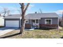 Charming single-story home boasts brick accents, a well-manicured lawn, and a two-car garage at 12510 Newton St, Broomfield, CO 80020