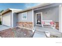 Inviting front porch with charming bench, brick accents, and a welcoming entrance at 12510 Newton St, Broomfield, CO 80020