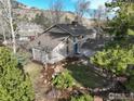 Inviting two-story home boasts a charming exterior, complemented by a lush yard and mature trees at 1425 Blue Sage Ct, Boulder, CO 80305