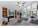 Stylish living room showcasing a fireplace, built-in shelves, large windows, and a comfortable seating area at 1425 Blue Sage Ct, Boulder, CO 80305