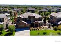 Expansive aerial view of a two-story home with a well-manicured front yard and mature landscaping at 1440 Eversole Dr, Broomfield, CO 80023