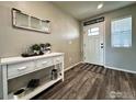 Cozy entryway with stylish console table, decor, and a bright, welcoming front door at 1495 Biffle Ct, Berthoud, CO 80513