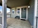 Inviting front porch features ample seating, a welcoming entry door, and classic exterior finishes at 1495 Biffle Ct, Berthoud, CO 80513