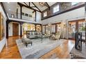 Spacious living room with vaulted ceilings, wood beams, hardwood floors and clerestory windows at 1652 Poplar Ave, Boulder, CO 80304