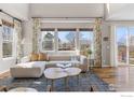 Sun-filled living room with hardwood floors, large windows, and stylish furniture at 1860 Pioneer Cir, Lafayette, CO 80026