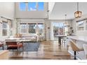 Open concept living and dining area with hardwood floors and abundant natural light at 1860 Pioneer Cir, Lafayette, CO 80026