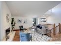 Bright living room with hardwood floors, fireplace, and a staircase to the second floor at 1880 Kohler Dr, Boulder, CO 80305