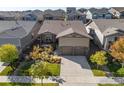 Aerial view of a well-maintained home with a manicured lawn, mature landscaping, and a two-car garage at 22646 E Glidden Dr, Aurora, CO 80016