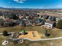 Expansive aerial view of a residential area showcases the home's proximity to a park and playground at 2285 Autumn Ridge Blvd, Lafayette, CO 80026