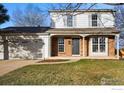 Charming two-story home with brick accents, a covered porch, and a well-maintained front lawn at 229 S Cleveland Ave, Louisville, CO 80027