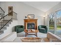 Cozy living room featuring a fireplace, vaulted ceiling, and comfortable seating at 229 S Cleveland Ave, Louisville, CO 80027