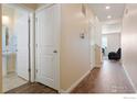 Inviting hallway with wood floors leading to other rooms at 2372 Mountain Sky Dr, Fort Lupton, CO 80621