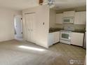 Bright kitchen view featuring white cabinets, tile flooring, and essential appliances at 3161 Madison Ave # 310, Boulder, CO 80303