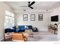 Bright living room featuring a comfortable blue sectional and natural wood accents at 3210 Iron Forge Pl # 103, Boulder, CO 80301