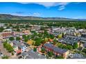 Scenic aerial view of the property in a neighborhood, showcasing mature trees and mountain views at 3215 Foundry Pl # 101, Boulder, CO 80301