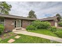 Close-up of the home's brick facade and well-maintained landscaping leading to the front door at 325 Fox Ct, Boulder, CO 80303