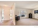 Bright living room with a large window and neutral walls and carpet at 325 Fox Ct, Boulder, CO 80303