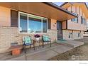 Inviting front porch with seating, perfect for enjoying a cup of coffee at 326 Berwick Ave, Firestone, CO 80520