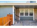 Close up view of a home's entrance with stone siding and a charming, fenced-in entryway at 3823 Paseo Del Prado, Boulder, CO 80301