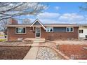 Charming brick single-story home with mature landscaping and inviting curb appeal at 4105 Yarrow Ct, Wheat Ridge, CO 80033