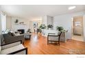 Bright living room featuring hardwood floors, fireplace, and neutral paint palette at 4105 Yarrow Ct, Wheat Ridge, CO 80033