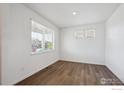Bright, airy bedroom with hardwood floors and ample natural light from a large window at 4113 Marble Dr, Mead, CO 80504