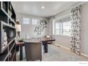 Well-lit office featuring a large window, custom shelving, and comfortable seating for a productive workspace at 4113 Marble Dr, Mead, CO 80504