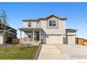 Charming two-story home featuring a welcoming front porch and a spacious three-car garage at 4115 Marble Dr, Mead, CO 80504