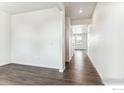 Bright hallway showcasing modern wood floors and seamless flow into adjacent spaces at 4115 Marble Dr, Mead, CO 80504