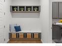 Functional mud room with built-in storage bench, wicker baskets, and overhead shelving at 420 Orion Cir, Erie, CO 80516