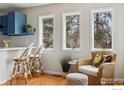 Sun-drenched breakfast nook features windows with a view of the outdoors, as well as a wicker seat at 4312 Black Cherry Ct, Boulder, CO 80301